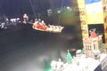 Santa in sleds flying over lego city