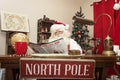 Santa Spends Time Relaxing with the Newspaper Royalty Free Stock Photo