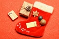 Santa stocking with christmas gift box. Christmas sock red background top view. Traditional christmas attribute Royalty Free Stock Photo