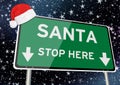 Santa stop here on signpost or billboard against starry sky at christmas or xmas night. Concept Image Royalty Free Stock Photo