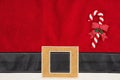 Santa suit textured background with a candy cane for your Christmas message Royalty Free Stock Photo