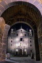 Santa Teresa church view through gate of the walls at night in Avila, Spain