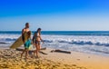 Santa Teresa, Costa Rica - June, 28, 2018: Couple of surfers on the beach of Santa Teresa walking and enjoying the time