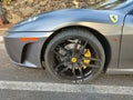 SANTA URSULA, SPAIN - JULY 10, 2023: Detail of the left side rim of a silver-colored Ferrari parked on a street