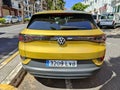 SANTA URSULA, SPAIN - JULY 23, 2023: Rear view of the yellow Volkswagen ID.4, a 100% SUV and 100% electric car with a large