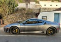 SANTA URSULA, SPAIN - JULY 10, 2023: Side view of a beautiful silver-gray Ferrari car, parked in a street of a town on the island