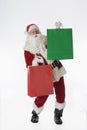 Santa on white background holding shopping bags