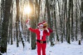 Santa in the winter field. Santa Claus on Christmas Eve is carrying presents to children in a bag. Xmas time with snow. Royalty Free Stock Photo