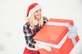 Santa woman holds a big gift box with copy space for your text. Christmas Girl holding a big gift. Big gift box. Crazy Royalty Free Stock Photo