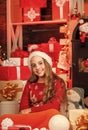 Santaland Diaries. cute playful christmas elf. little girl red santa hat. santa claus residence. present delivery