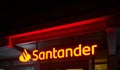 Santander Bank illuminated billboard with the name of the financial institution in the pedestrian zone of Wolfsburg, Germany,