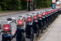 Santander cycles bikes for rent parked at docking station. Many red bicycle. London, UK - October 22, 2021