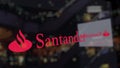 Santander Serfin logo on the glass against blurred business center. Editorial 3D rendering