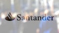 Santander Serfin logo on a glass against blurred crowd on the steet. Editorial 3D rendering