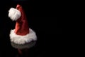Santas cap on black Royalty Free Stock Photo