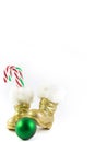 Santas golden boots with Christmas ball and candy canes Royalty Free Stock Photo