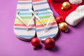 Santas hat and flip flops with christmas bubbles Royalty Free Stock Photo