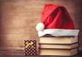 Santas hat over books near gift box Royalty Free Stock Photo