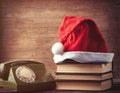 Santas hat over books near green dial phone Royalty Free Stock Photo