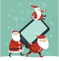 Santas with huge smartphone