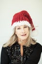 Santas little helper. Beautiful happy senior woman with a santa claus hat