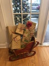 Santas Sleigh Full of Gifts with Christmas Tree in Background