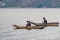 SANTIAGO ATITLAN, GUATEMALA - MARCH 23, 2016: Fishermen on traditional wooden boats on Atitlan lake near Santiago Royalty Free Stock Photo