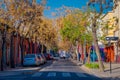 SANTIAGO, CHILE - SEPTEMBER 13, 2018: Cars parked under trees at one side of the street in the Barrio Yungay in Santiago