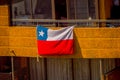 SANTIAGO, CHILE - SEPTEMBER 13, 2018: Outdoor view of Chilean flag hanging from a balcony of a building in the city of