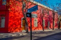 SANTIAGO, CHILE - SEPTEMBER 13, 2018: Outdoor view of red building surrounding of trees with an informative sign of name