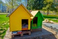 SANTIAGO, CHILE - SEPTEMBER 17, 2018: Outdoor view of two dog wooden yellow and green houses at Forestal park located in Royalty Free Stock Photo