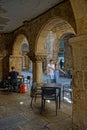 A small bar under the shadows and lights of the arcades of Santiago old town streets