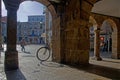 Under the shadows and lights of the arcades of Santiago old town streets