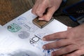 Santiago de Compostela, Spain; April 19, 2019; Pilgrim stamping a identification named The Compostela the accreditation of the