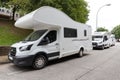 Group of modern camper van parked on a city street. Concept of summer tourism with