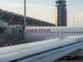 Parts of an IBERIA airplane in front of the tower and the departure gate of the local airports