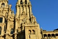 Cathedral with sunset light and clean stone. Obradoiro Square, Santiago de Compostela, Spain. Facade and tower details with statue