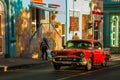 Santiago de Cuba, Cuba: Street locals and a vintage car red