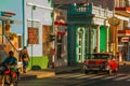 Santiago de Cuba, Cuba: Street locals and a vintage car red