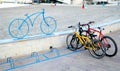 Santiago de la Ribera, Murcia, Spain - July 31 2018: Bicycles parked in a bike rack, marked by a modern wrought iron sculpture of