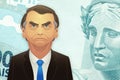 Santo AndrÃÂ©/SÃÂ£o Paulo/Brazil - April 10, 2020: Illustration of the brazilian president, Jair Bolsonaro, in front of a banknot