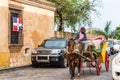 SANTO DOMINGO, DOMINICAN REPUBLIC - AUGUST 8, 2017: The coachman in a retro carriage on a city street. Copy space for text. Royalty Free Stock Photo