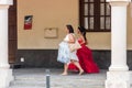 SANTO DOMINGO, DOMINICAN REPUBLIC - AUGUST 8, 2017: Two women in beautiful dresses on a city street. Copy space for text.