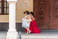 SANTO DOMINGO, DOMINICAN REPUBLIC - AUGUST 8, 2017: Two women in beautiful dresses on a city street. Copy space for text.