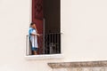 SANTO DOMINGO, DOMINICAN REPUBLIC - AUGUST 8, 2017: Woman on the balcony. Copy space for text.