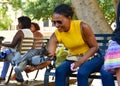 Santo Domingo, Dominican Republic. Woman feeds pigeons on Columbus Park, Colonial Zone of Santo Domingo.