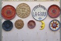 View colorful ceramic plates on the wall of one of the pottery souvenir shops