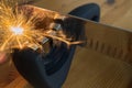 Sparks fly, while sharpening Santoku knife.