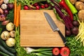 Santoku Knife on Wooden Chopping Board with Fresh Vegetables Background. Healthy Eating Concept. Royalty Free Stock Photo