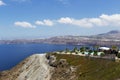Santorini, Caldera, view of a rocky cliff with a beautiful pool and green palm trees, the sea, in the background a view of Royalty Free Stock Photo